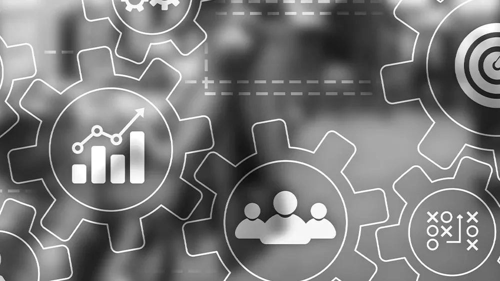 Transparent gear icons with business symbols over a blurred office background.
