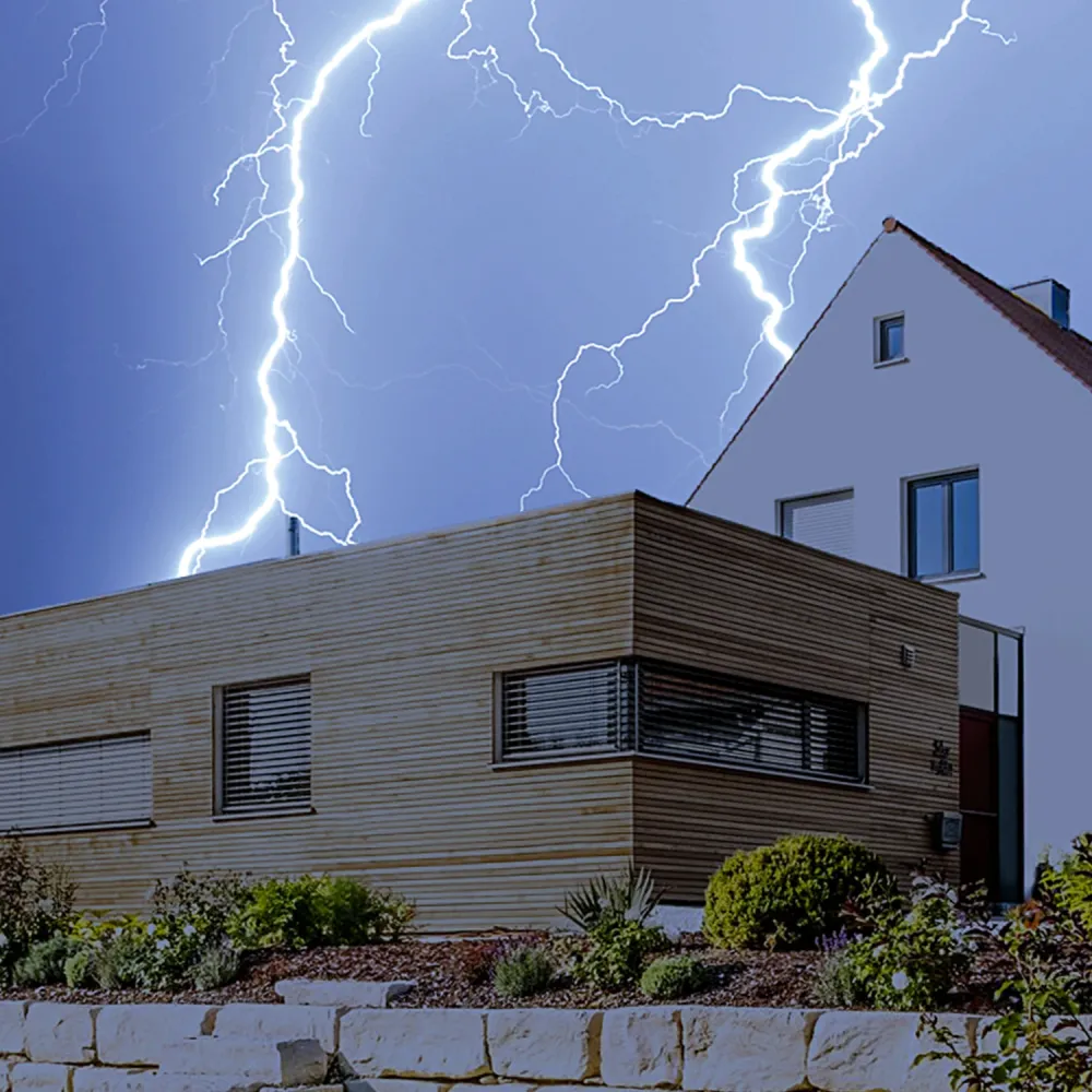 Lightning striking near residential house illustrating need for lightning protection and surge protection system