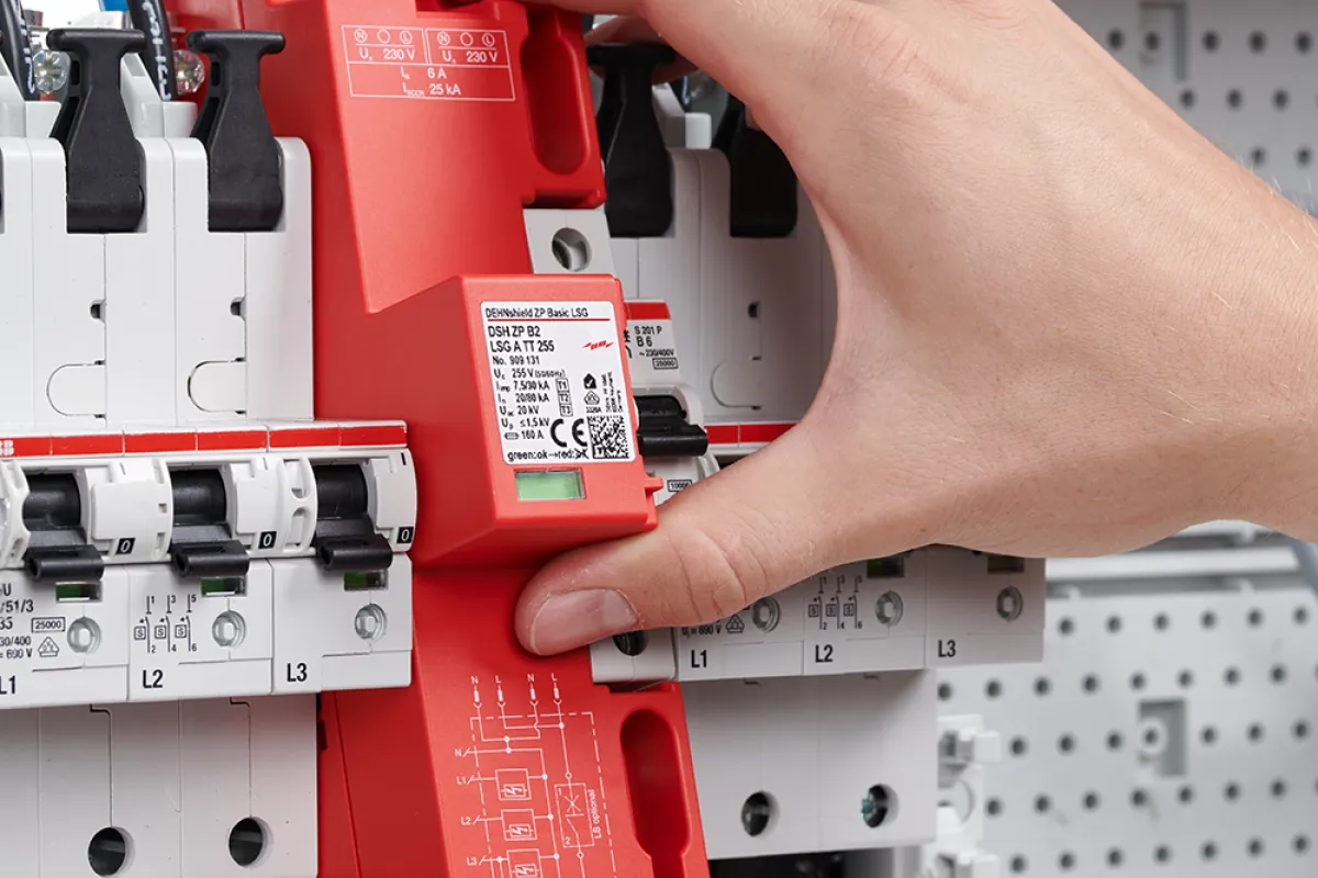 Close-up of an electrical distribution board showing circuit breakers, wiring, and a prominent DEHNshield ZP surge protection device.