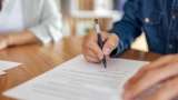 a man signing a contract
